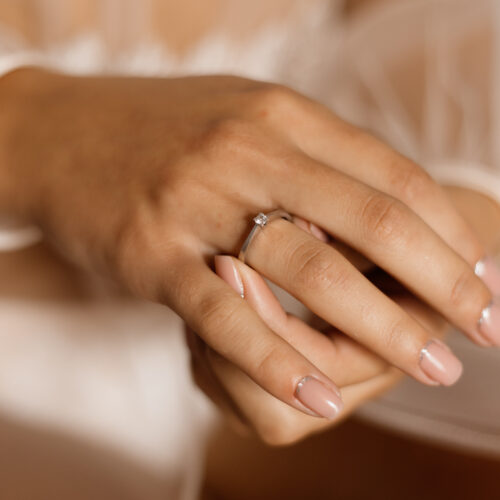 Tender girl's hands with engagement ring with diamond and beauti